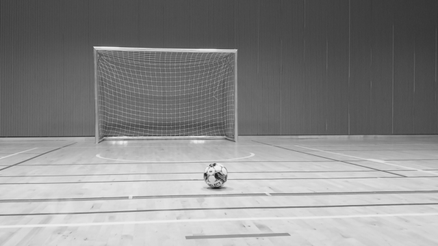 black and white photo of futsal goal and futsal ball